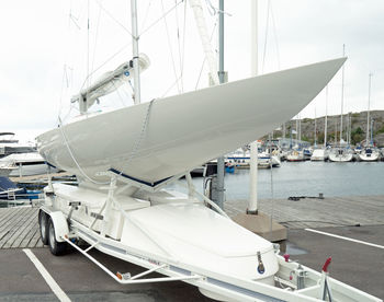 Sailboats moored at harbor