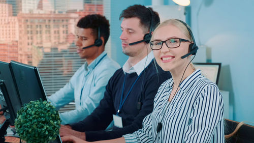 Portrait of smiling businesswoman using digital tablet in office