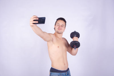 Full length portrait of young man photographing