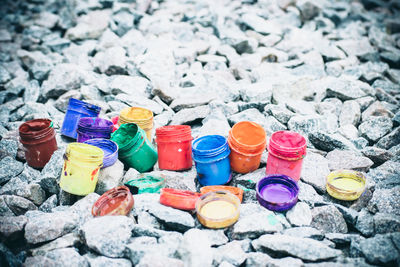 High angle view of multi colored bottles on stones