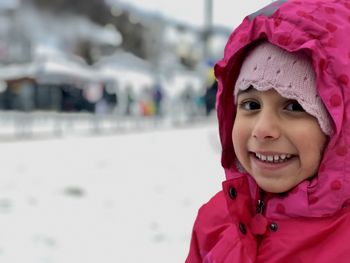 Portrait of smiling pre-schooler enjoying snow for the first time