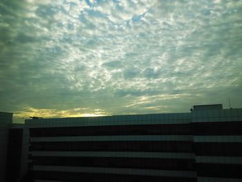 Low angle view of building against cloudy sky