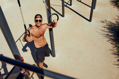 Low angle view of boy swinging at playground