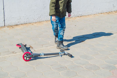 Low section of man riding bicycle on footpath