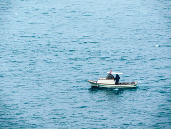 Man in boat sailing on sea