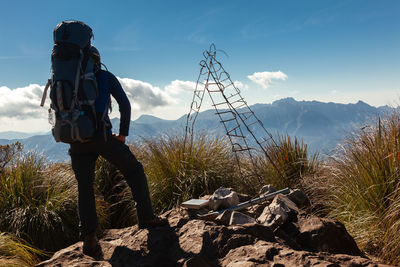 Man standing on mountain against sky