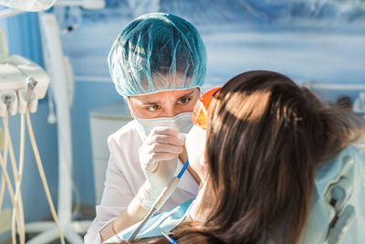 Dentist examining teeth of patient