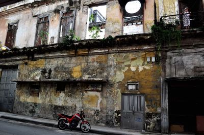 Motorcycle on street amidst buildings in city