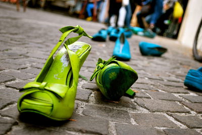 Low section of green shoes on footpath