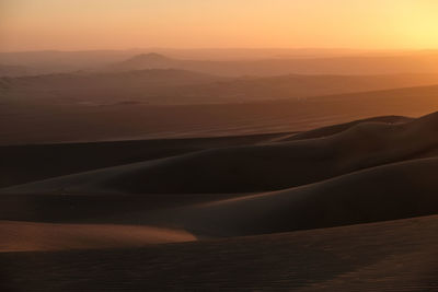 Scenic view of desert against sky during sunset