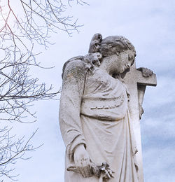 Low angle view of statue against sky