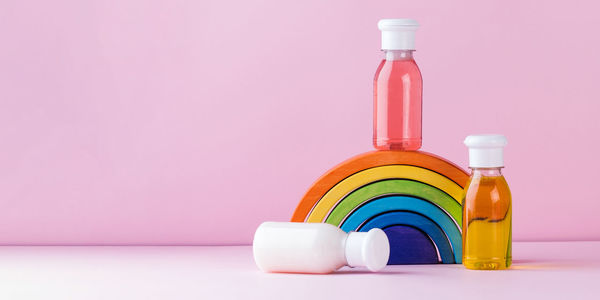 Mockup multicolored plastic bottles with shower gel, shampoo for children and adults. copy space.