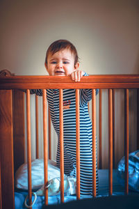 Cute boy looking through railing