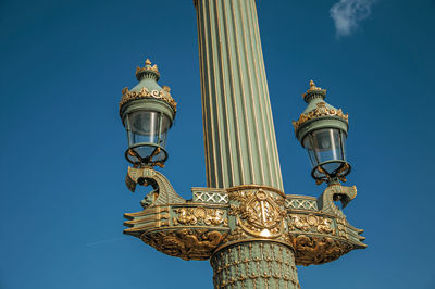 Low angle view of street light against building