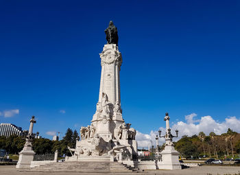 Low angle view of statue against blue sky