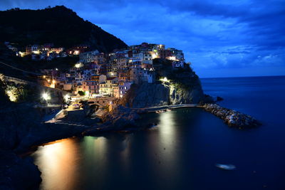 High angle view of townscape by sea against sky