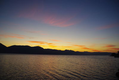 Scenic view of sea against romantic sky at sunset