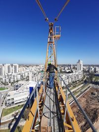 Panoramic view of buildings against clear blue sky