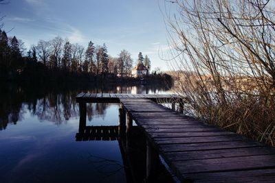 Pier over lake against sky