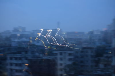 Close-up of cityscape against clear blue sky