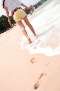 Low section of woman at beach