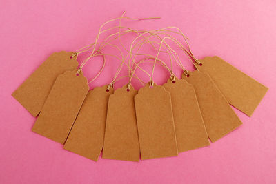 High angle view of pink paper against colored background