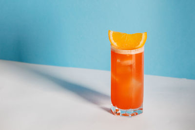 Close-up of drink in glass against blue background