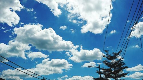 Low angle view of power lines against sky