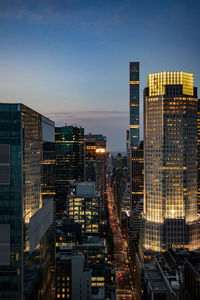 High angle view of illuminated buildings against sky at dusk