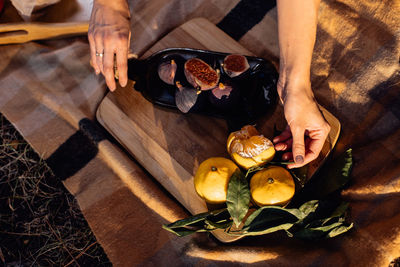 High angle view of hand holding drink on table