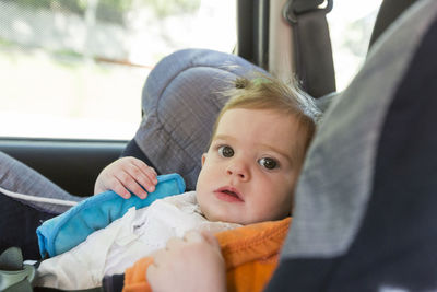Portrait of cute baby in car