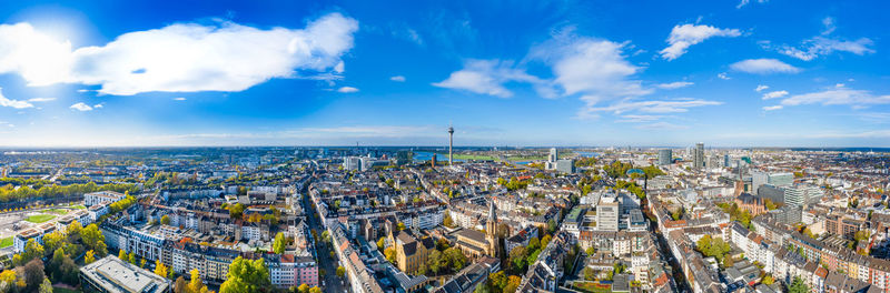 High angle view of city buildings against cloudy sky