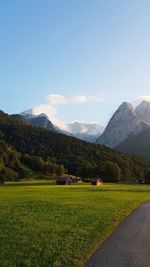 Scenic view of field and mountains against sky