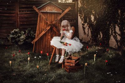 Girl sitting on wood