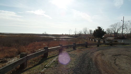 Scenic view of field against cloudy sky