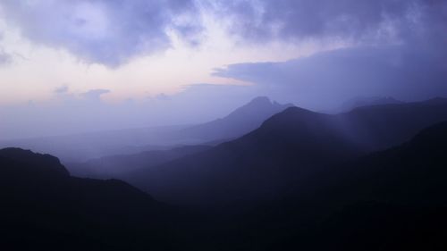 Scenic view of silhouette mountains against sky at dusk