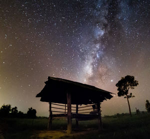 Built structure on field against sky at night