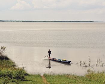 Man rowing boat in sea