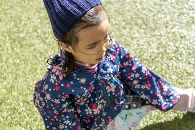 High angle view of girl standing on grass outdoors