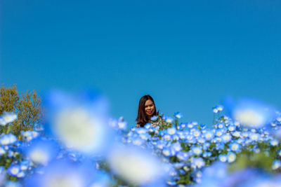 Full length of woman against blue sky