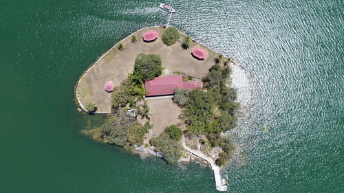 High angle view of lake amidst trees and buildings