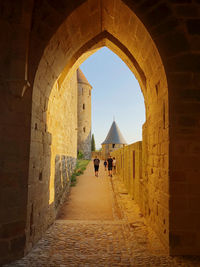 People walking in old building