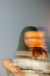 Digital composite image of young woman against gray background