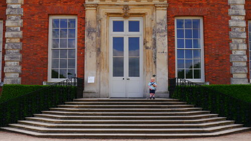Man standing on staircase of building