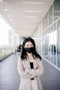 Young business woman wearing face mask in city. corona virus concept