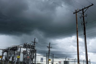 Low angle view of electricity pylon against sky