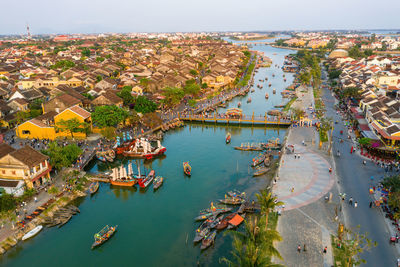 High angle view of townscape by sea against sky