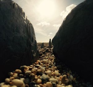 Close-up of pebbles in desert against sky