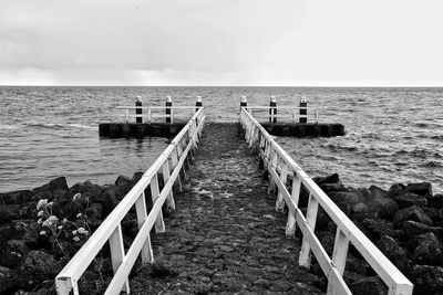 Pier over sea against sky