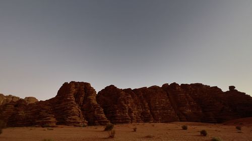 Rock formations on landscape against clear sky